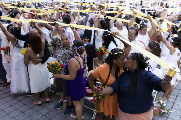 Couples, whose weddings were cancelled or diminished during the COVID-19 pandemic, participate in a symbolic multicultural ceremony at Damrosch Park, New York, on Sunday.