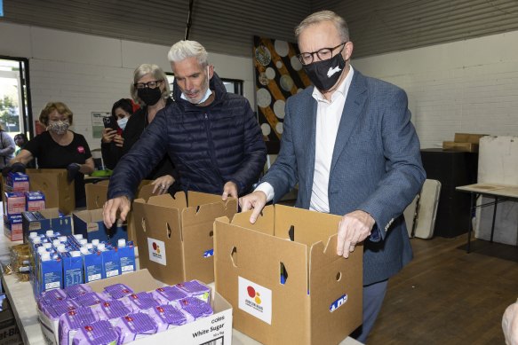 Foster with then Opposition leader Anthony Albanese and businesswoman Sam Mostyn packing food hampers at the Addison Road Community Centre last May.