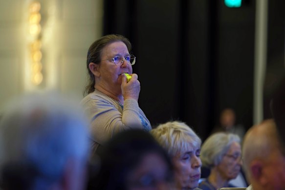 A protester disrupts the meeting by blowing a whistle during the annual general meeting at Crown in Perth