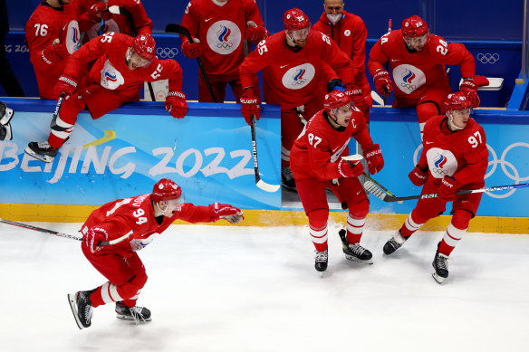 Team ROC skate onto the ice to celebrate its victory over Sweden in the men’s ice hockey semifinal at the Beijing Olympics on Friday.
