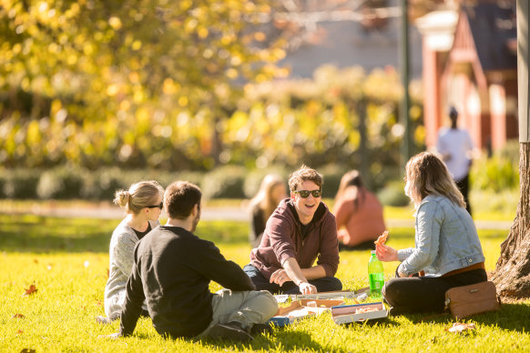 People enjoying the sun in Carlton Gardens