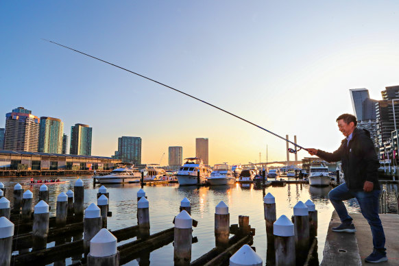 Zhi Yuan fishes off the old pier in Docklands.