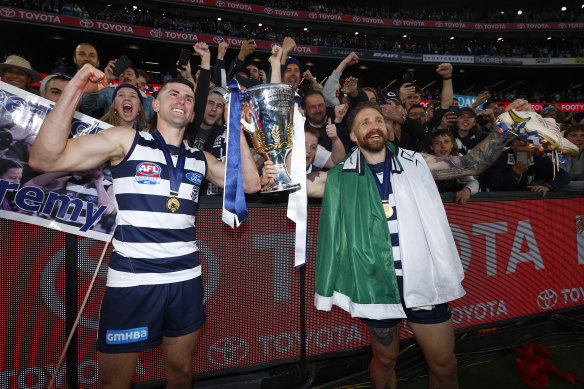 Mark O’Connor (left) celebrates the AFL grand final win with Irish teammate Zach Tuohy.