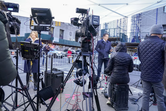 Television crews prepare for their live shots outside the Manhattan criminal courts.