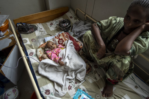 Birhan Etsana sits with her malnourished daughter Mebhrit, who at 17-months old weighs just 5.2 kilograms. 