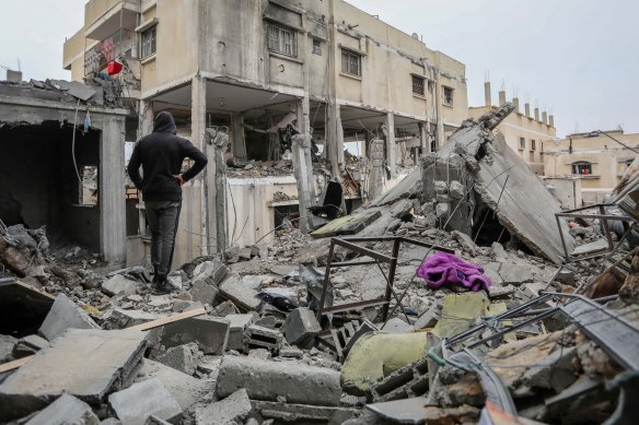 People inspecting the damage and recovering items from their homes following Israeli air strikes in Rafah.