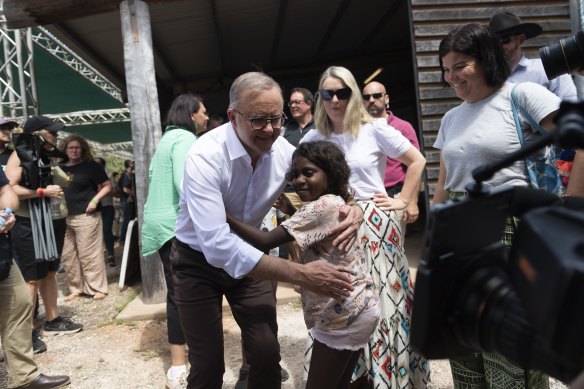 Prime Minister Anthony Albanese embraces a child after his Garma keynote speech.