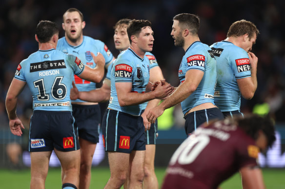 Mitchell Moses and James Tedesco celebrate.