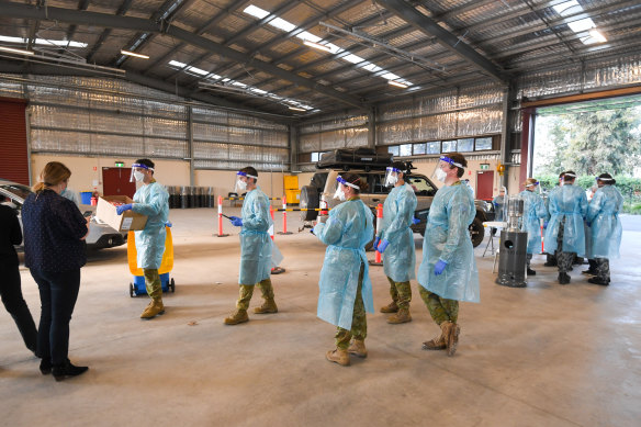 Boots on the ground: ADF personnel perform COVID-19 testing at the Shepparton showgrounds.