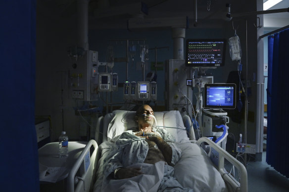 A COVID-19 patient receives treatment in an ICU.