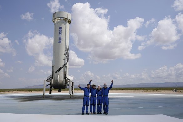 Jeff Bezos, second from left, in front of the rocket that landed safely after their launch from the spaceport near Van Horn, Texas, on July 20. 