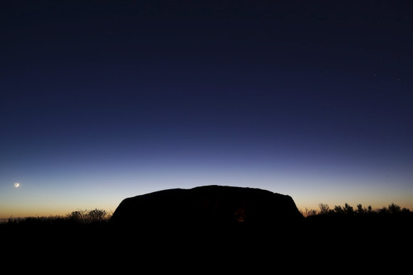 The Saturday sun rises over Uluru, the first morning after the climb was permanently closed.