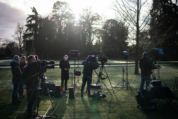 Members of the media prepare to broadcast from within the Sandringham estate near King's Avenue ahead of Prince Harry arriving to meet with Queen Elizabeth II.