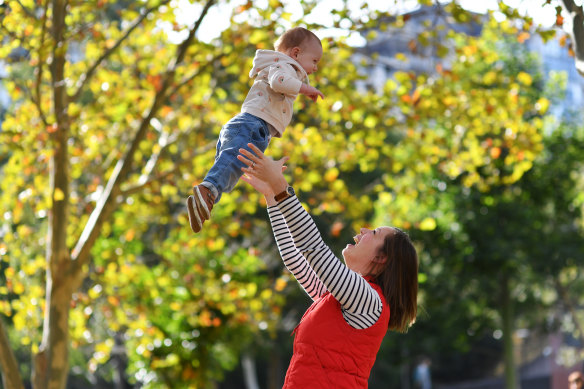 Taking flight: Molly Fleck with 14-month-old son TJ in Surry Hills on Saturday. The family will relocate to the US because of Australia’s travel ban.
