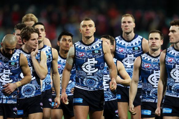 Patrick Cripps leads the Blues off the field after the loss against Sydney.