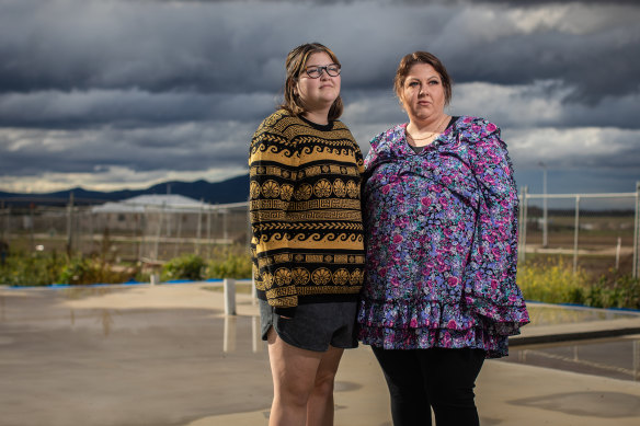 Kate Saha with daughter Armahni on the slab of their delayed new home in the Austin Lara estate, north of Geelong.