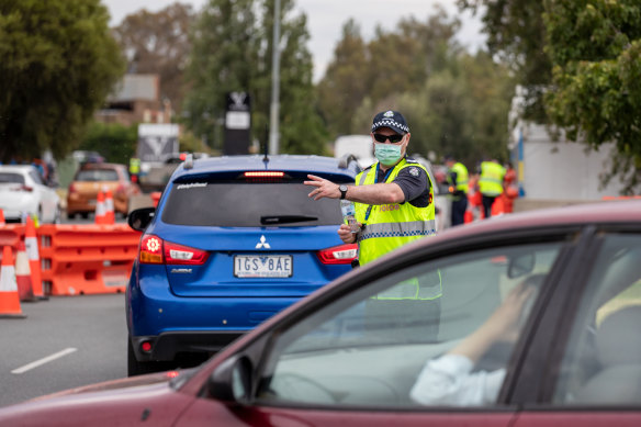 Victoria Police stop motorists entering the state from NSW at Albury on Friday.