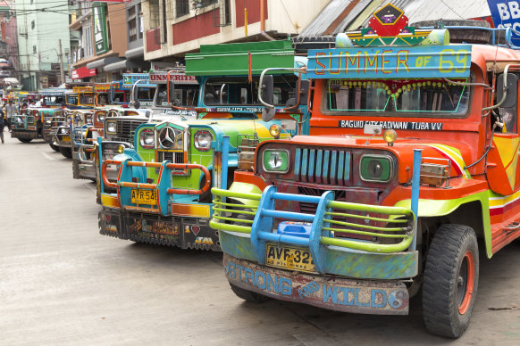 A Manila institution… multi-coloured Jeepneys seen lined up at a station.