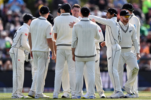 Matt Henry is congratulated by teammates for one of his seven wickets. 
