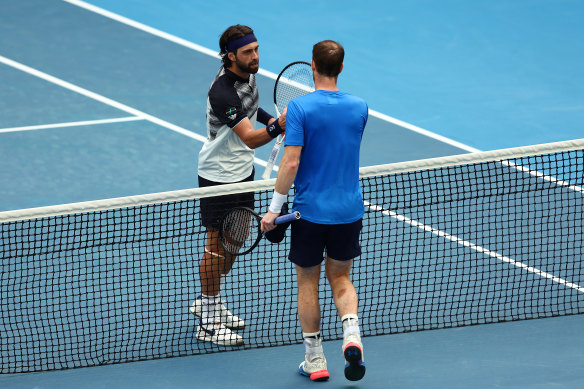 Andy Murray and Nikoloz Basilashvili shake hands. 