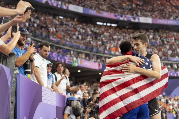 Hamish Kerr of New Zealand, right, embraces Shelby McEwen of the United States, after Kerr took gold and McEwen silver in the men’s high jump.