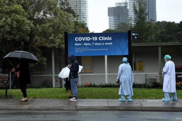 Health workers line up with the public at the coronavirus COVID-19 clinic at Concord Hospital on Wednesday.