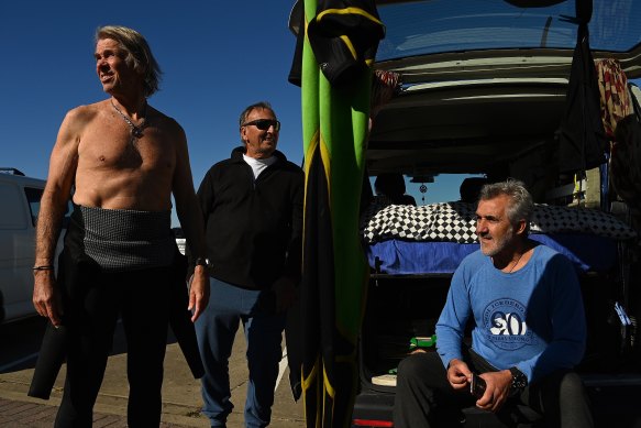 Eastern suburbs residents and long-time friends Henry Brycki, Bill Kriketos and Stan Peters went for a surf on a quieter-than-usual Bondi Beach on Friday. 
