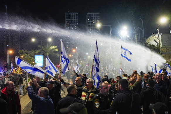 Police use water cannons to disperse demonstrators during a protest against Israeli Prime Minister Benjamin Netanyahu’s government in Tel Aviv.