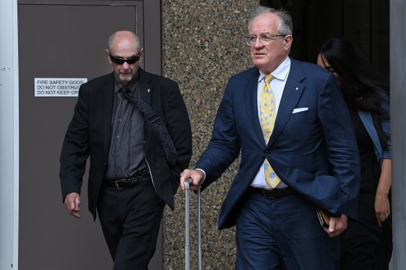 Chris Dawson’s older brother Peter Dawson (left) and defence lawyer Greg Walsh (right) leave the Law Courts building in Queens Square on Friday.