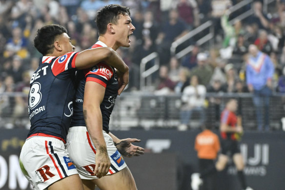 Joseph Manu celebrates a try for the Roosters.