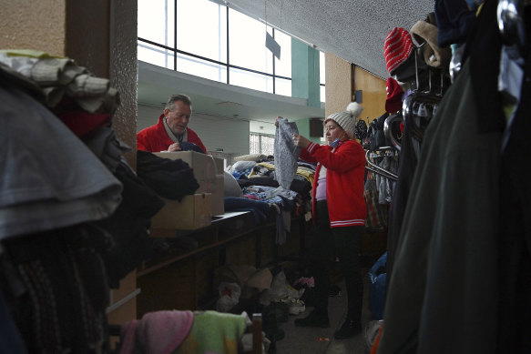 Red Cross Ukraine workers sort donated clothing in Zaporizhzhia.