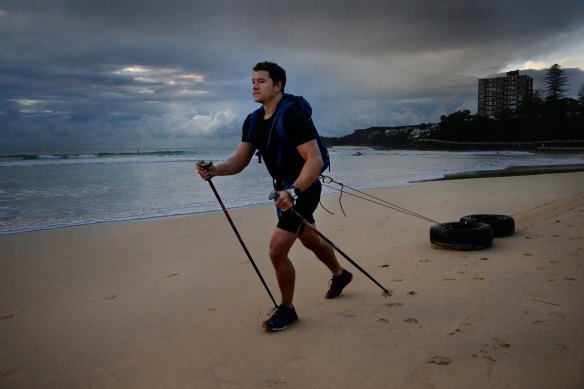 Gareth Andrews pulls tyres along Manly Beach for up to six hours as part of his training for The Last Great First, a 110-day trek across Antarctica.