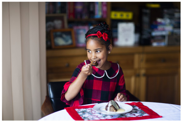 Fifth-generation Talia, 6, enjoys her Ray’s Traditional Home Made Plum Pudding at a family gathering. 