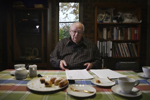 Terry Goulden reads his police file at home in Wentworth Falls.