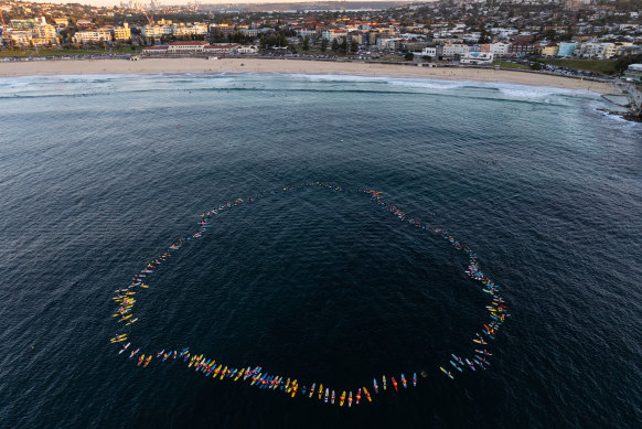 Hundreds of surfers form a circle off Bondi Beach in memory of those killed at the Bondi Junction stabbing attack.
