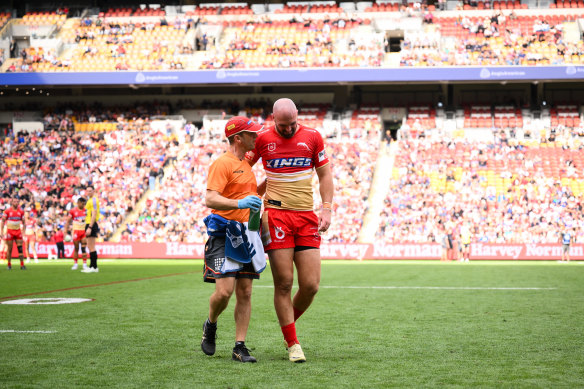 An injured Mark Nicholls leaves the field.