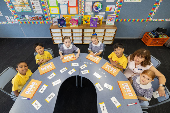 Students at Bethany Catholic Primary School in Werribee North practise their phonics skills with principal Joanne Webster.