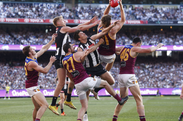 Harris Andrews flies in front of opponent Billy Frampton (rear) reels in a great pack mark for Brisbane.