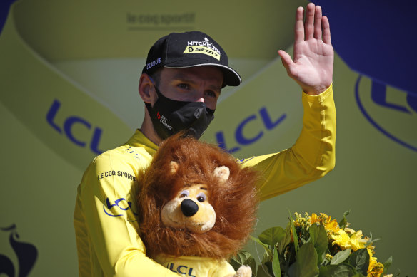 Adam Yates wearing a mask and the coveted yellow jersey.