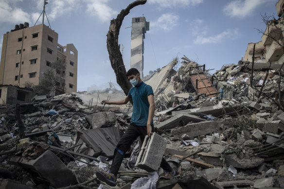 A Palestinian man inspects the damage after a six-storey building was destroyed by an Israeli air strike in Gaza.