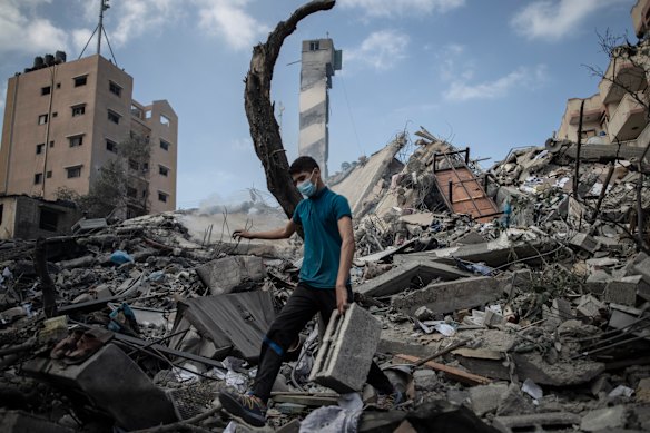 A Palestinian man inspects the damage after a six-storey building was destroyed by an Israeli air strike in Gaza.