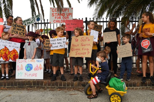 Orange Grove Primary School students and parents demand urgent action on climate change outside the school gates on Thursday morning. 
