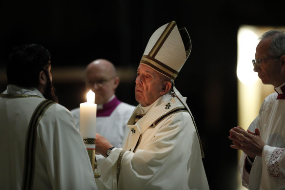 Pope Francis presides over a solemn Easter vigil ceremony in a nearly empty St Peter's Basilica.