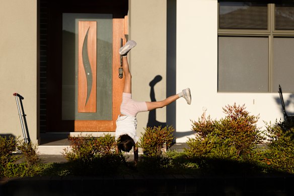 A child plays in the front yard.