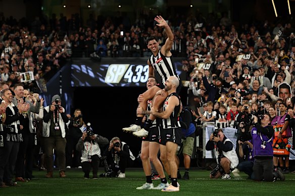 Pendlebury chaired off the MCG by great mates and premiership teammates Steele Sidebottom and Jeremy Howe.