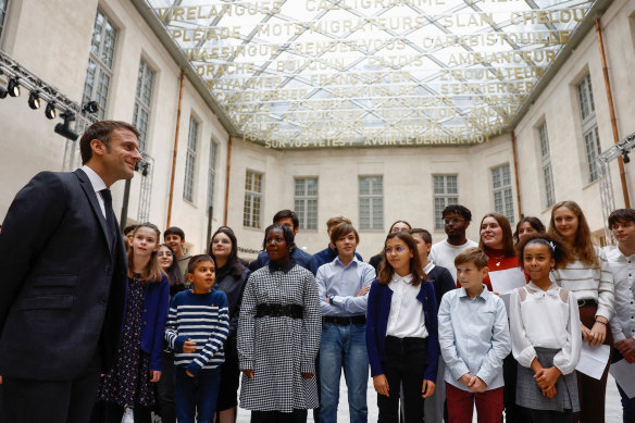 French President Emmanuel Macron and students at the Cite Internationale de la Langue Francaise, a cultural centre dedicated to the French language and French-speaking cultures at the castle of Villers-Cotterets on Monday.