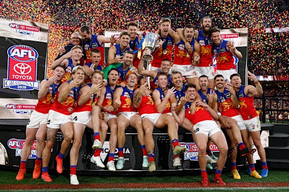 The Lions celebrate winning a third-straight grand final. 