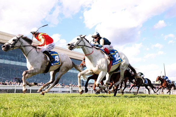 John Allen (left) rides Kingswood to win the Caulfield Cup.