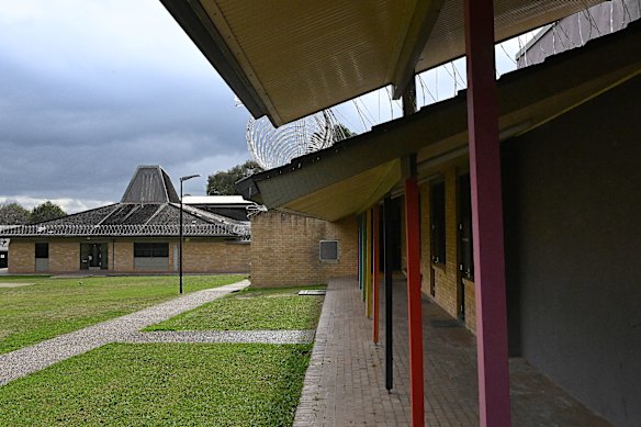 Bright paint and rolls of barbed wire on  the buildings at the centre.