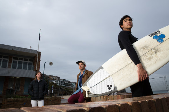 Bella Keating-Follas, Tom Chapman and Luke Morris of the Bronte Boardriders are among those who object to an expansion of the surf club building that would encroach on public space at the Sydney beach.